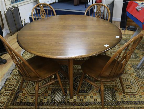 An Ercol oak drop leaf dining table and four chairs